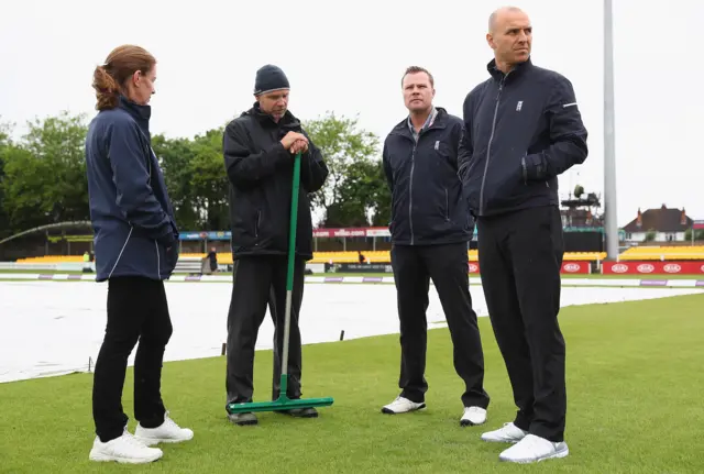 Umpires and ground staff at Grace Road