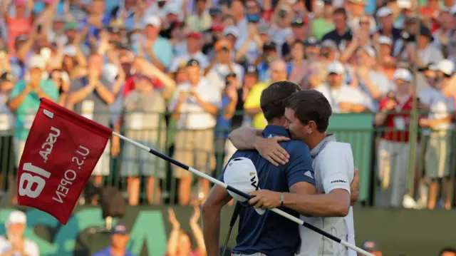 Dustin Johnson and his caddie