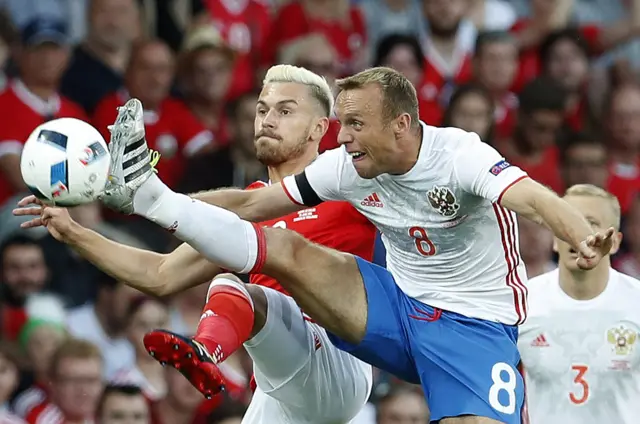 Aaron Ramsey challenges for the ball