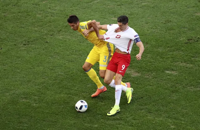 Robert Lewandowski challenges for the ball