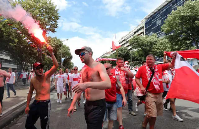 Poland fans lite a flare