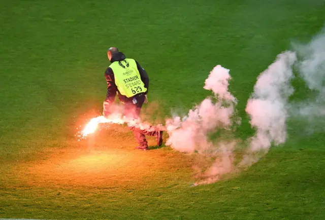 A steward runs with a flare