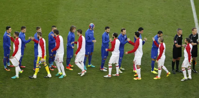 Players shake hands