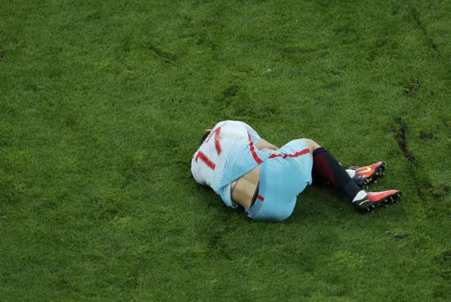 Burak Yilmaz lies on the pitch