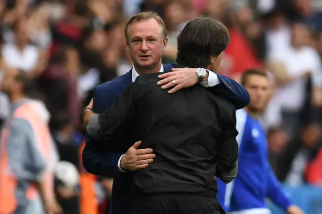 Michael O'Neill congratulates Germany's coach Joachim Loew