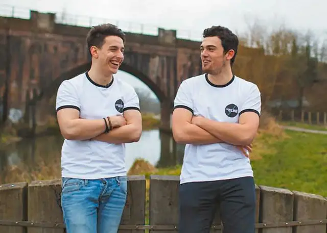 Ollie Baines and Liam Flint, standing in front of a bridge