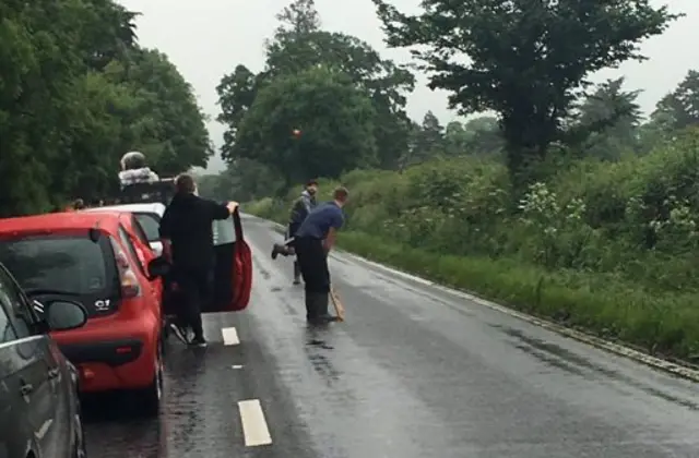 People playing cricket in the road