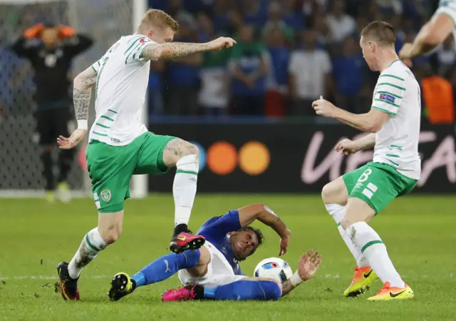 James McClean and James McCarthy challenge for the ball