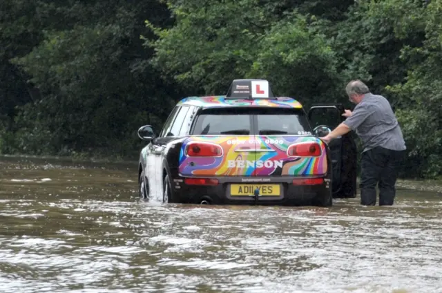 Driving school car in flood waters