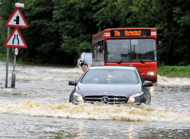 Traffic driving on flooded road