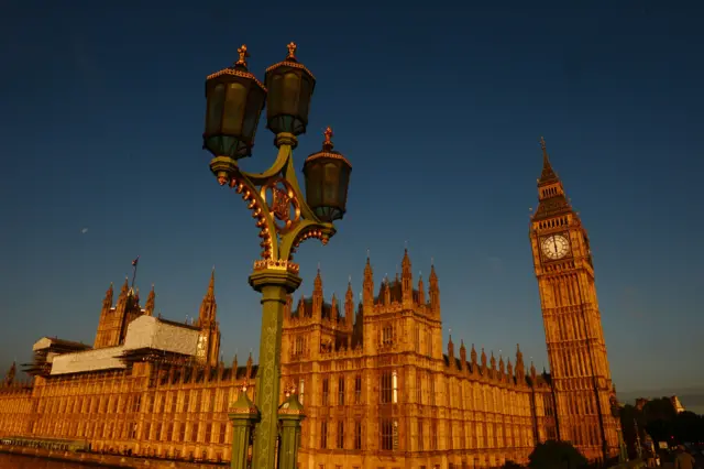 The rising sun illuminates the Houses of Parliament in London