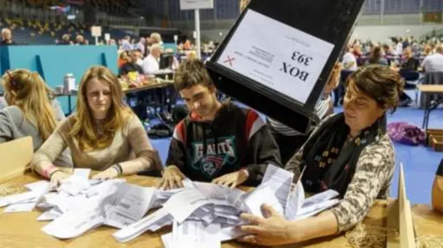 Workers empty ballot box at count