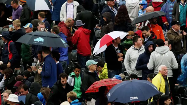 Fans put up umbrellas