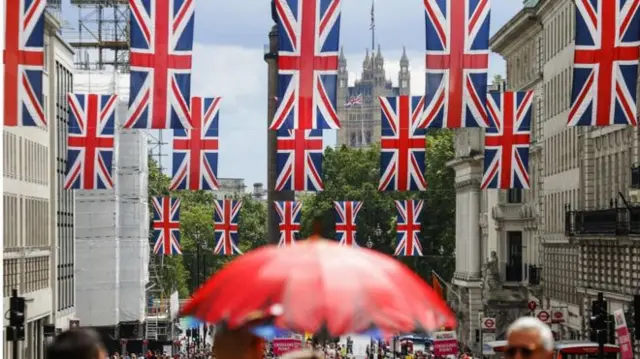 Union Jacks with the House of Commons in the background