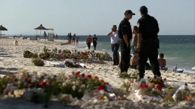 Beach in Tunisia with floral tributes