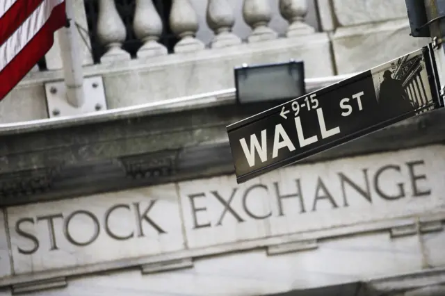 Wall Street sign with Stock Exchange sign behind