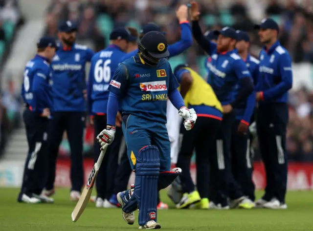 Perera walks after his dismissal