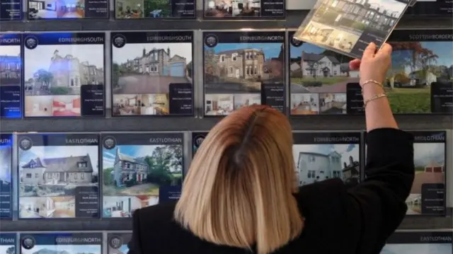 Woman looking at property details