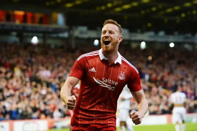 Adam Rooney celebrates his late penalty