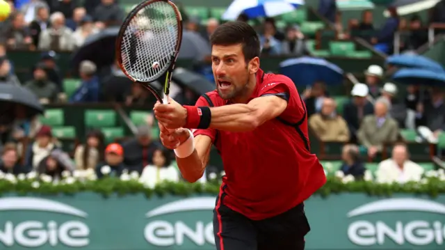 Novak Djokovic stretches for a backhand