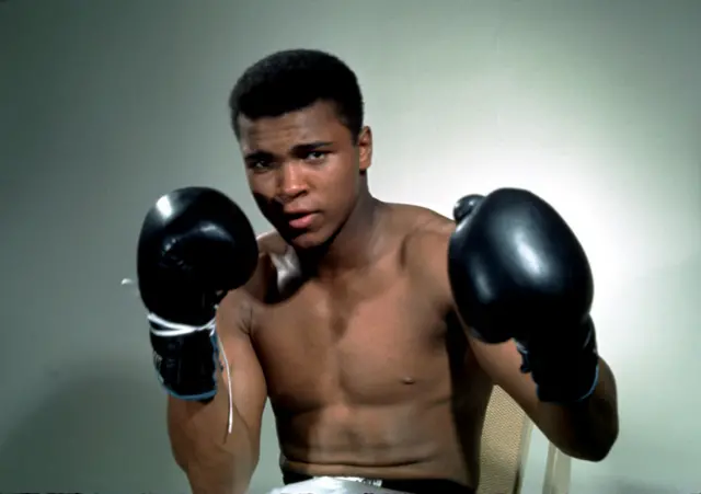 Muhammad Ali poses with gloves in this undated photograph