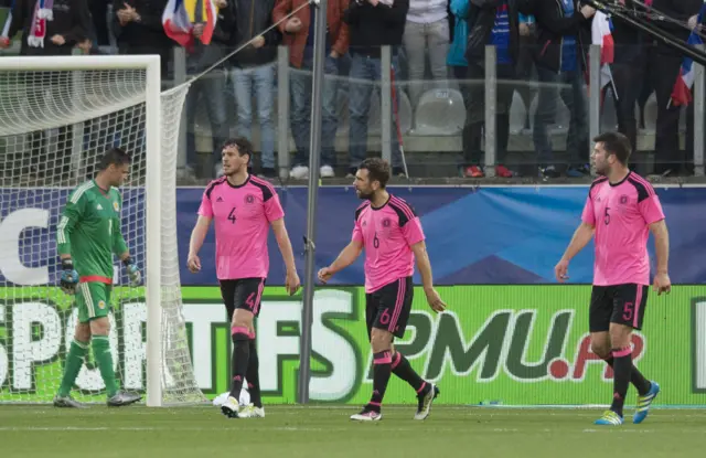 A quartet of Scots look around in dismay at France's opener.