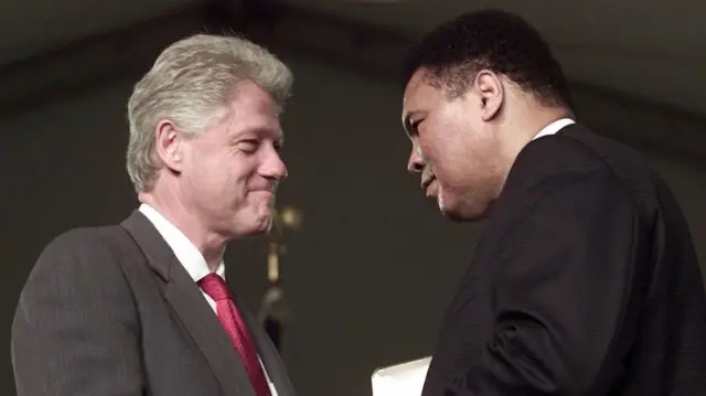 US President Bill Clinton presents boxing legend Muhammad Ali with the Presidential Citizens Medal during ceremonies 08 January 2001 at the White House in Washington, DC