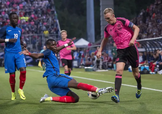 France's Paul Pogba battles for the ball against Scotland's Darren Fletcher.