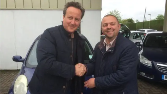 david cameron shaking car dealers hand
