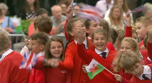 Children waving flags at the royal vist