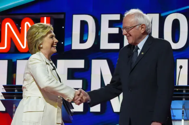 US Democratic presidential candidates Hillary Clinton (L) and Bernie Sanders shake hands before the CNN Democratic Presidential Debate at the Brooklyn Navy Yar on April 14, 2016, in New York.