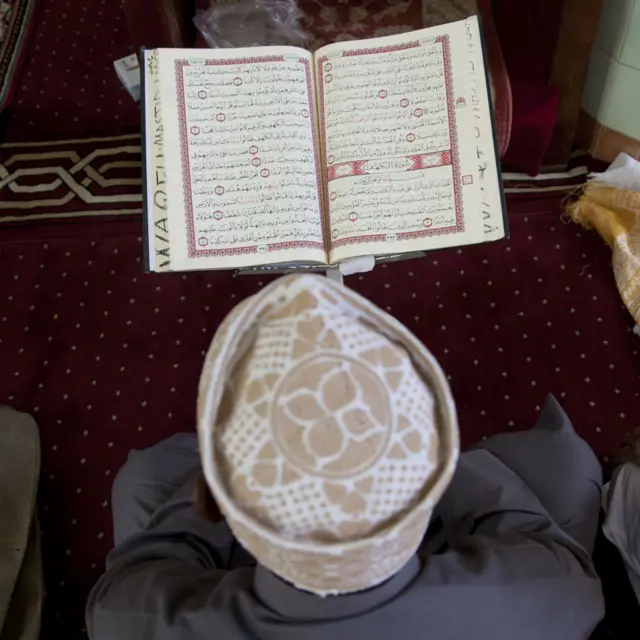 A man reading from a Koran in a mosque in Kenya