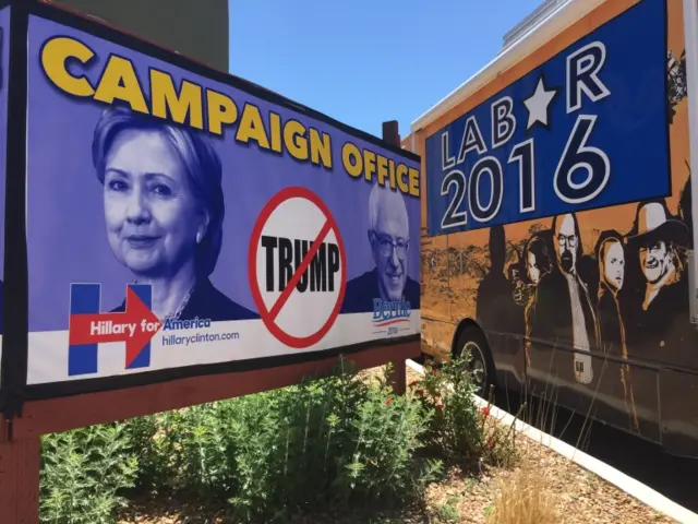 Adverts for the Clinton and Sanders campaigns appear side by side in Santa Fe