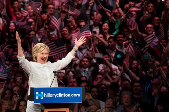 Democratic presidential candidate Hillary Clinton gestures to the crowd at the start of her remarks during a primary night rally at the Duggal Greenhouse in the Brooklyn Navy Yard, June 7, 2016 in the Brooklyn borough of New York City.