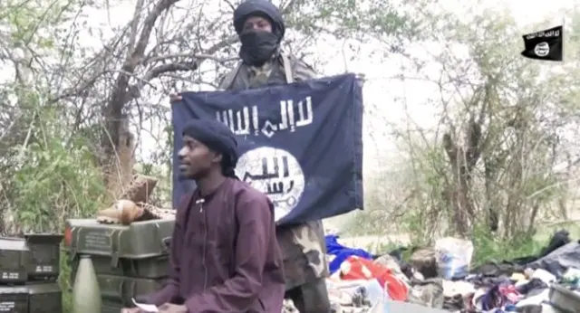 Boko Haram militants showing the IS black flag