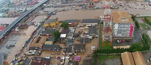 Buildings and shops in rising flood waters