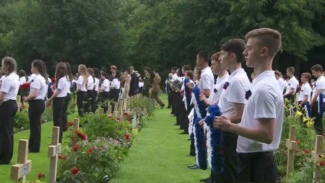 children prepare to lay wreaths