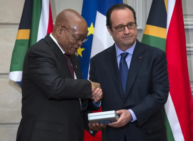 French President Francois Hollande, right, gives an audio recording of Nelson Mandela to South Africa"s President Jacob Zuma before their press conference at the Elysee Palace in Paris, Monday, July 11, 2016