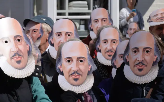 People wearing Shakespeare masks