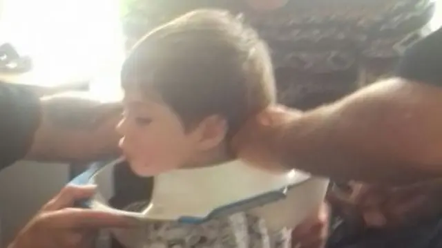 Boy with toilet seat on head