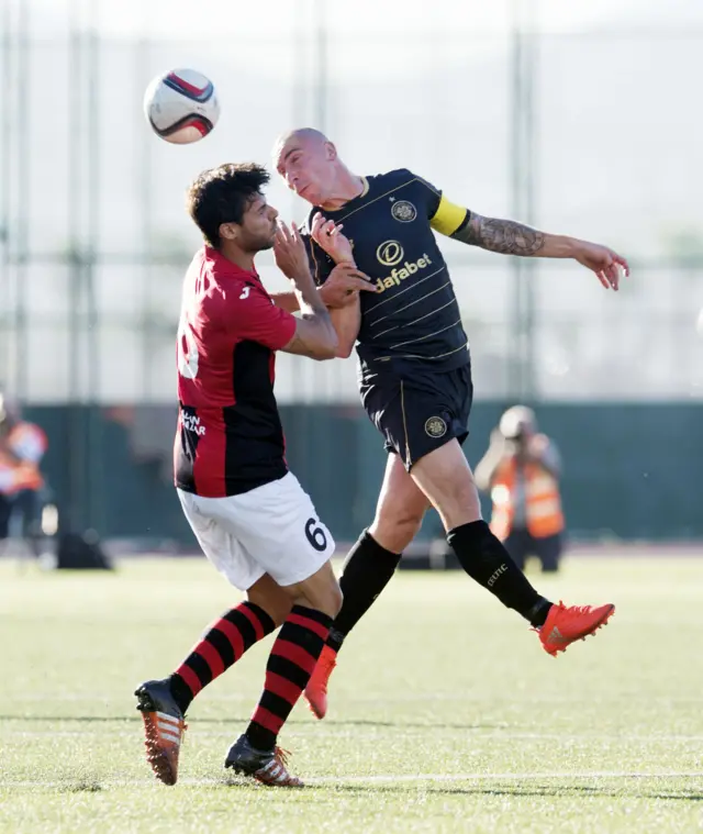 Celtic's Scott Brown (right) battles for the ball against Lincoln's Bernado Lopes Morgado