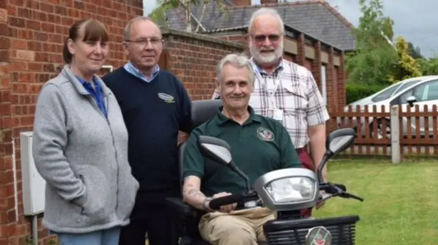 Steve Lobb and friends with his scooter