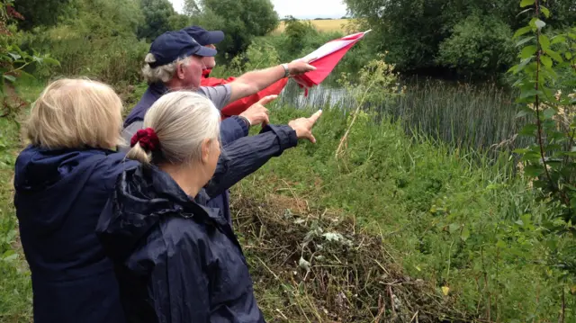 Residents point to site of planned bridge