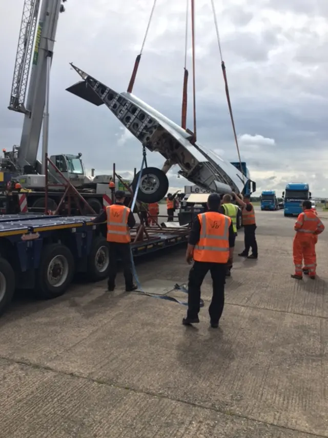 Aircraft wing being loaded onto lorry