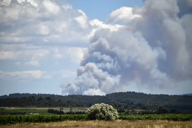 Smoke billows in the distance