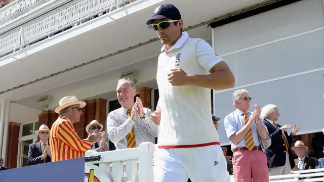 Alastair Cook comes onto the field