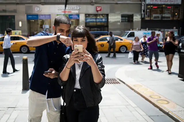 Two people playing Pokemon Go