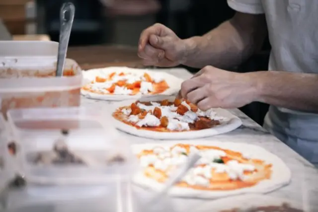 Franco Manca chef makes pizzas