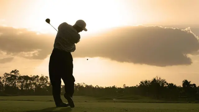 Golfer teeing off