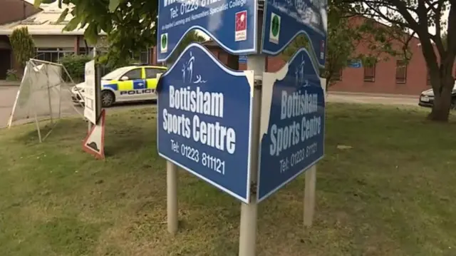 Bottisham sports centre sign with police car in the background